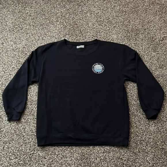 This Ron Jon crewneck is a women’s large and dark grey color - Picture 1 of 2